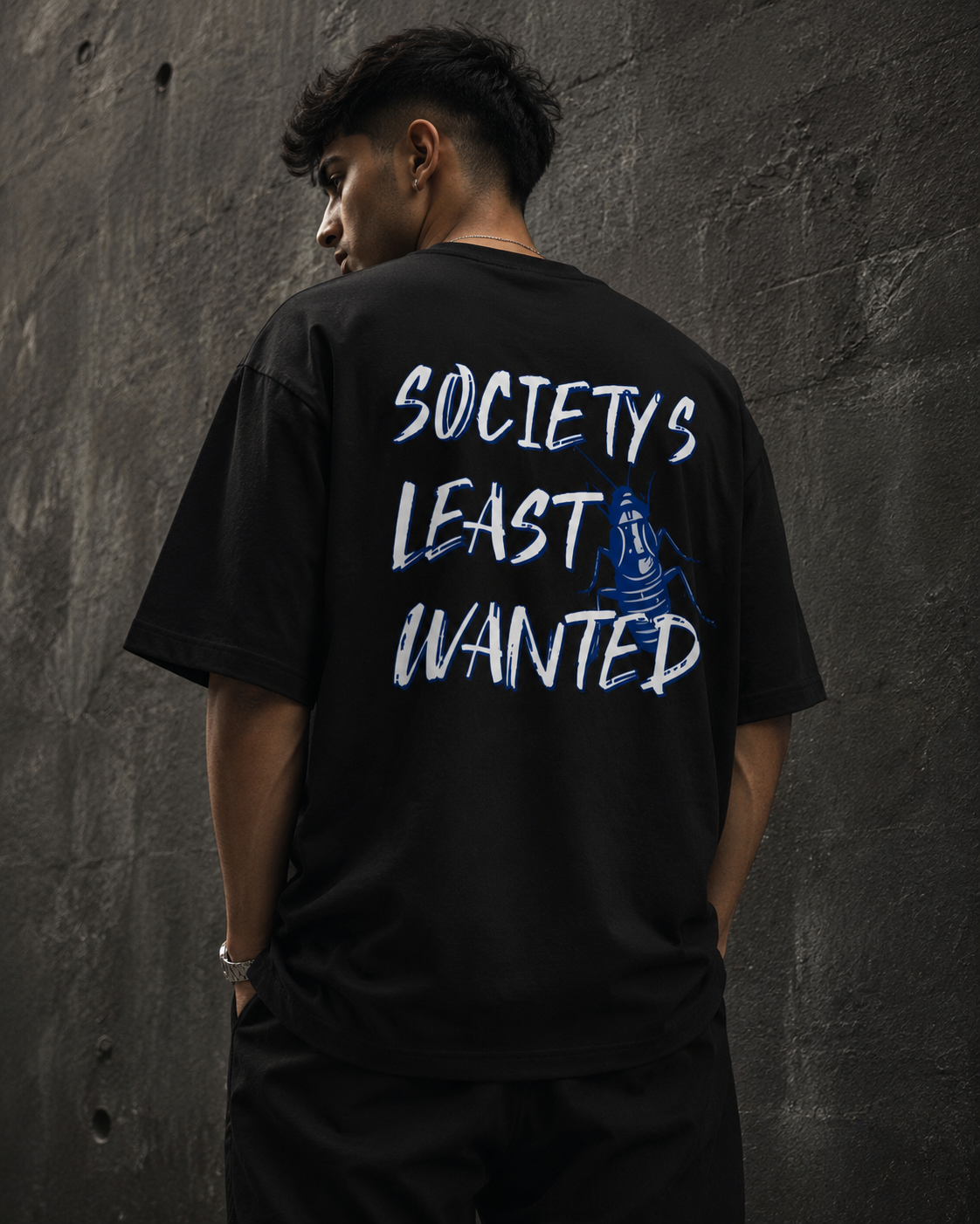 Black Cockroach Society's Least Wanted Premium Oversized T-Shirt in urban streetwear lifestyle setting with blue cockroach artwork
