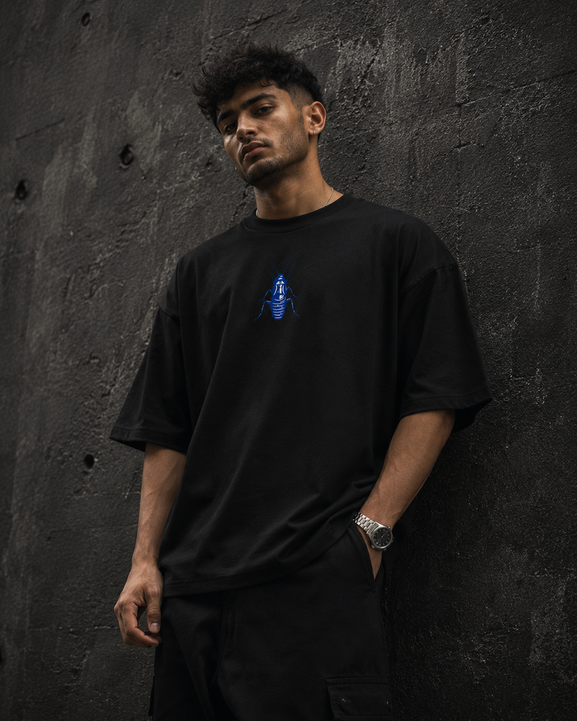 Black Cockroach Society's Least Wanted Premium Oversized T-Shirt front view with blue cockroach chest graphic