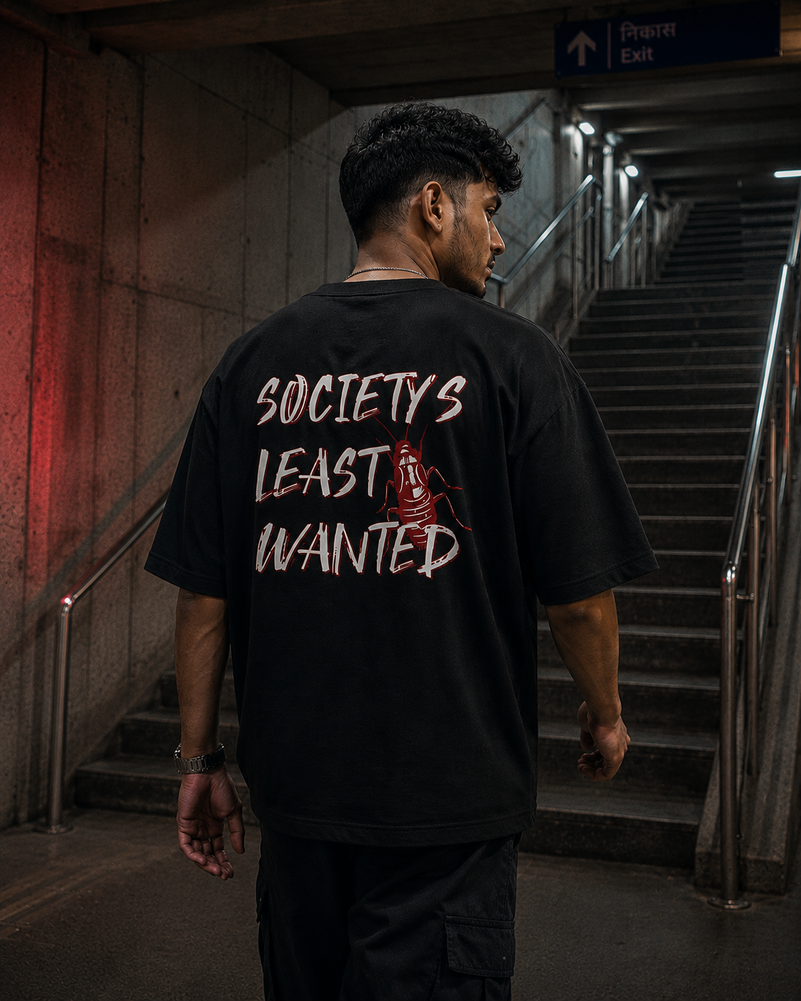 Black Cockroach Society's Least Wanted Premium Oversized T-Shirt in urban streetwear lifestyle setting with red cockroach artwork