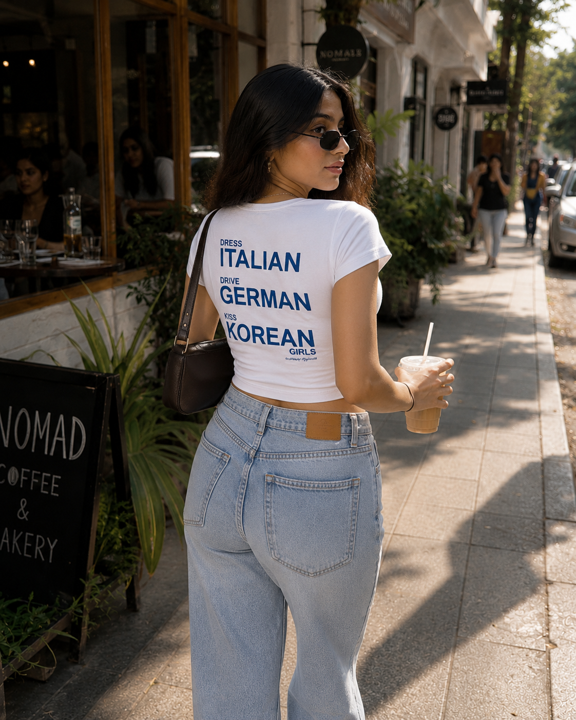 White Drip Earth female baby tee with GLOBAL CODE graphic - lifestyle streetwear shot
