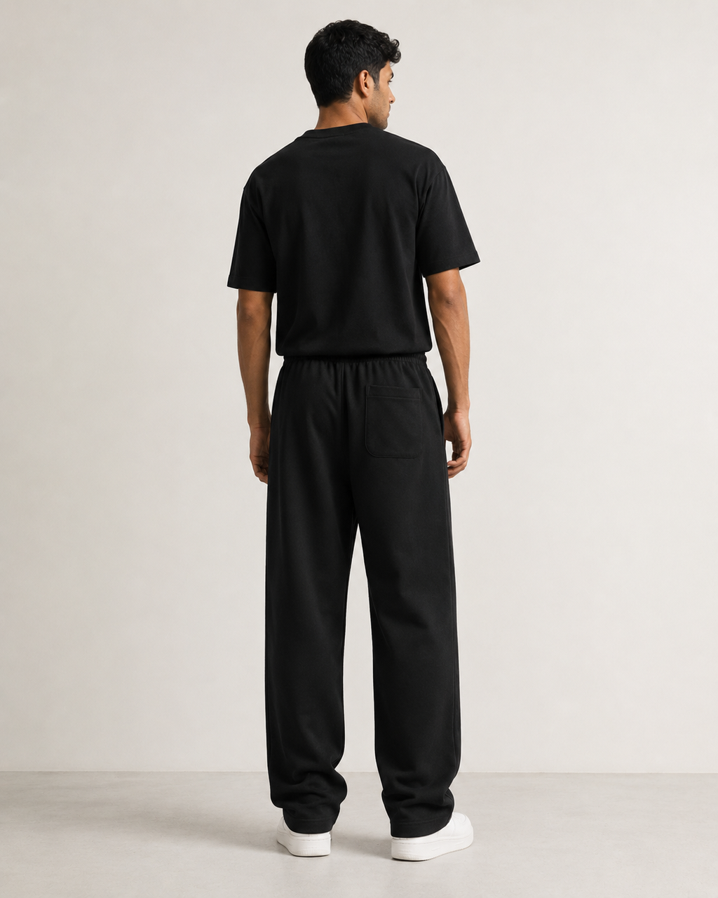 Black Drip Earth relaxed sweatpants - rear model studio view with clean silhouette