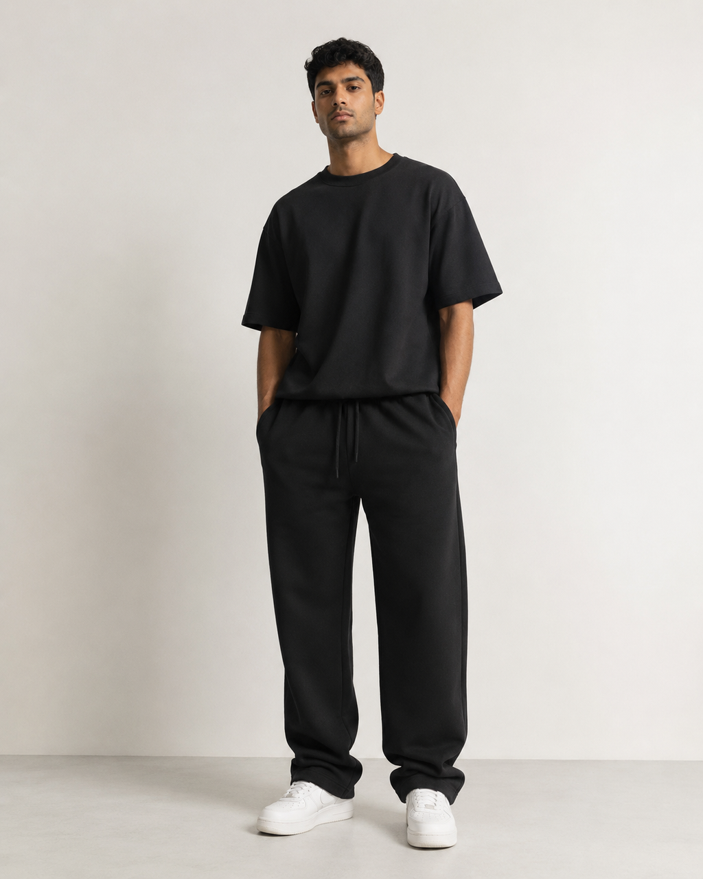Black Drip Earth relaxed sweatpants - front model studio view with premium fit