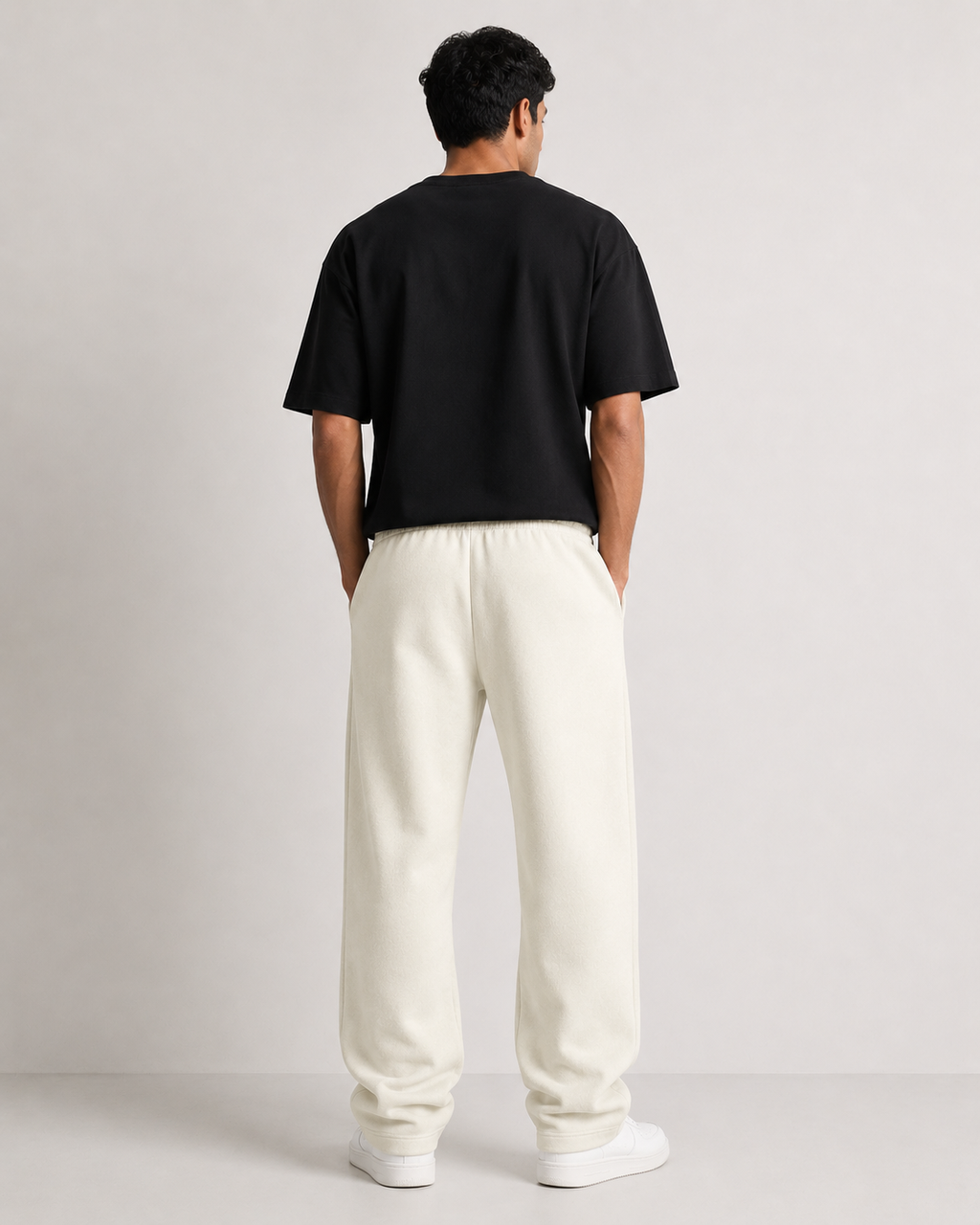 Off-White Drip Earth relaxed sweatpants - rear model studio view with clean silhouette