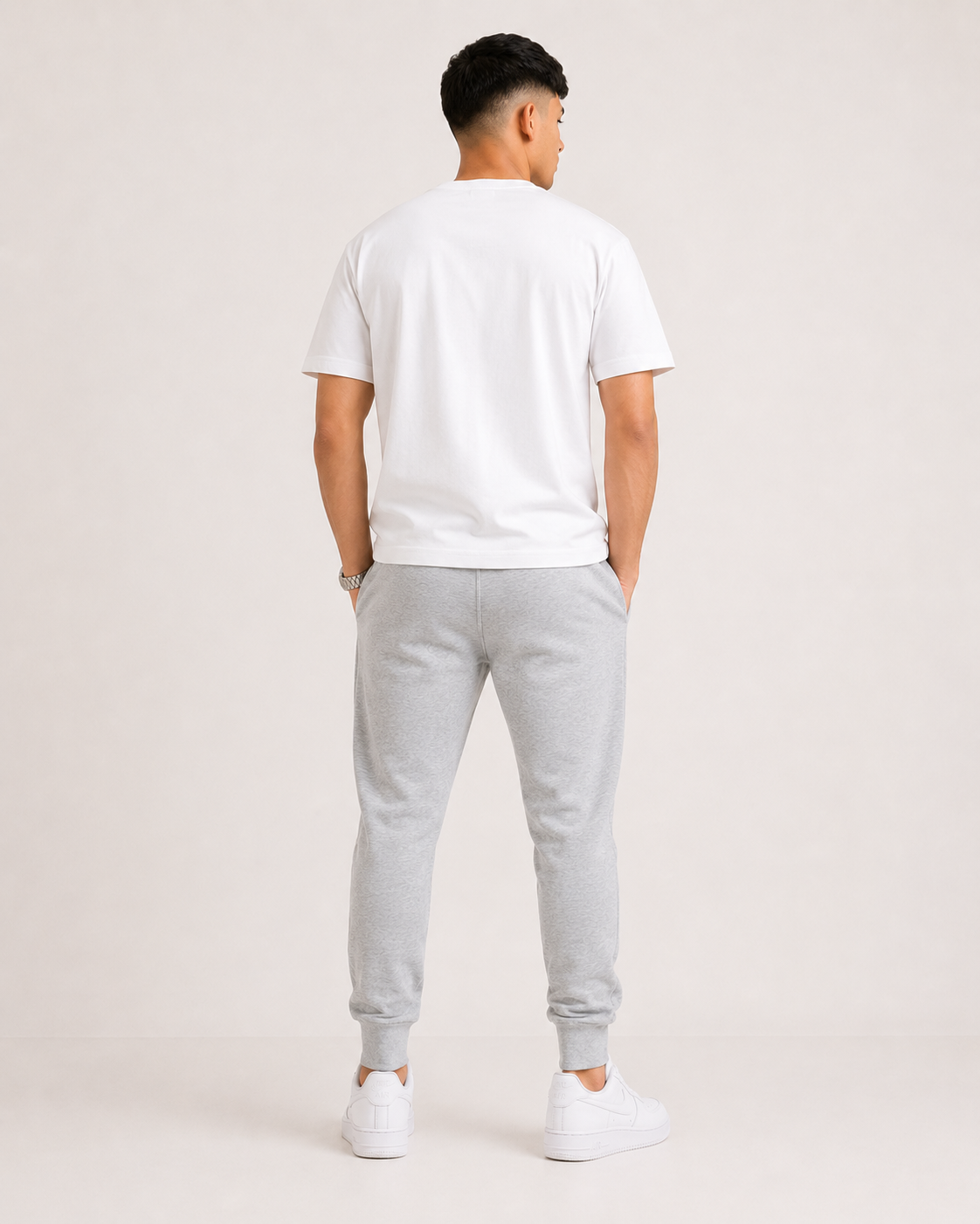 Grey-Melange Drip Earth tapered joggers - rear model studio view with clean silhouette