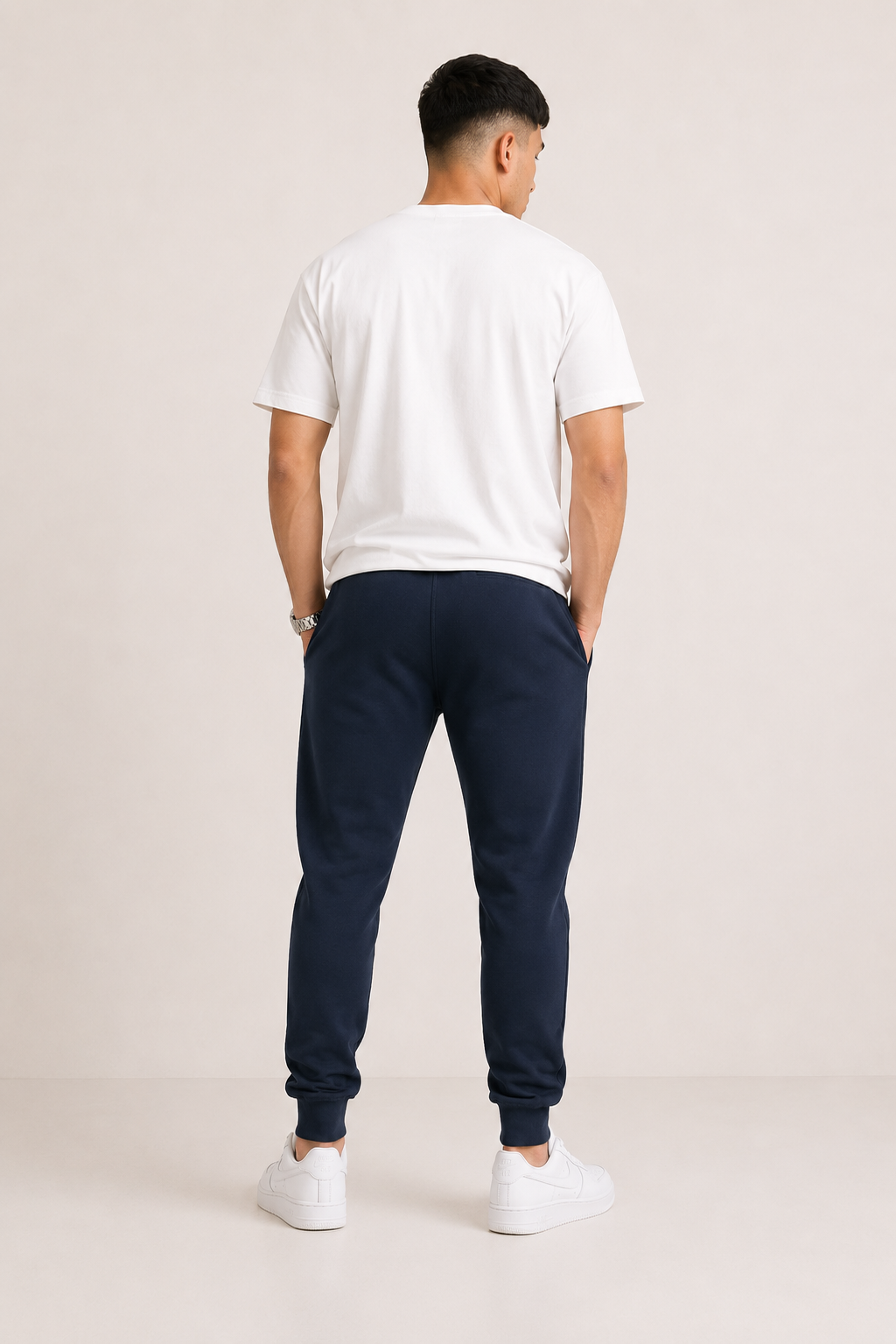 Navy-Blue Drip Earth tapered joggers - rear model studio view with clean silhouette