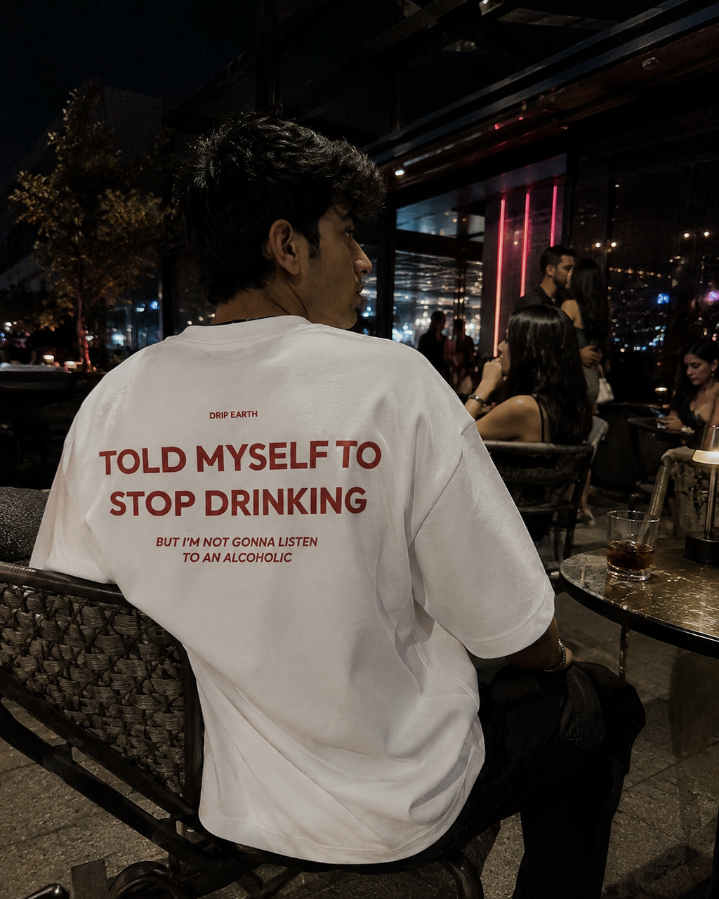 White Drip Earth oversized heavyweight t-shirt with STOP DRINKING graphic - lifestyle streetwear shot
