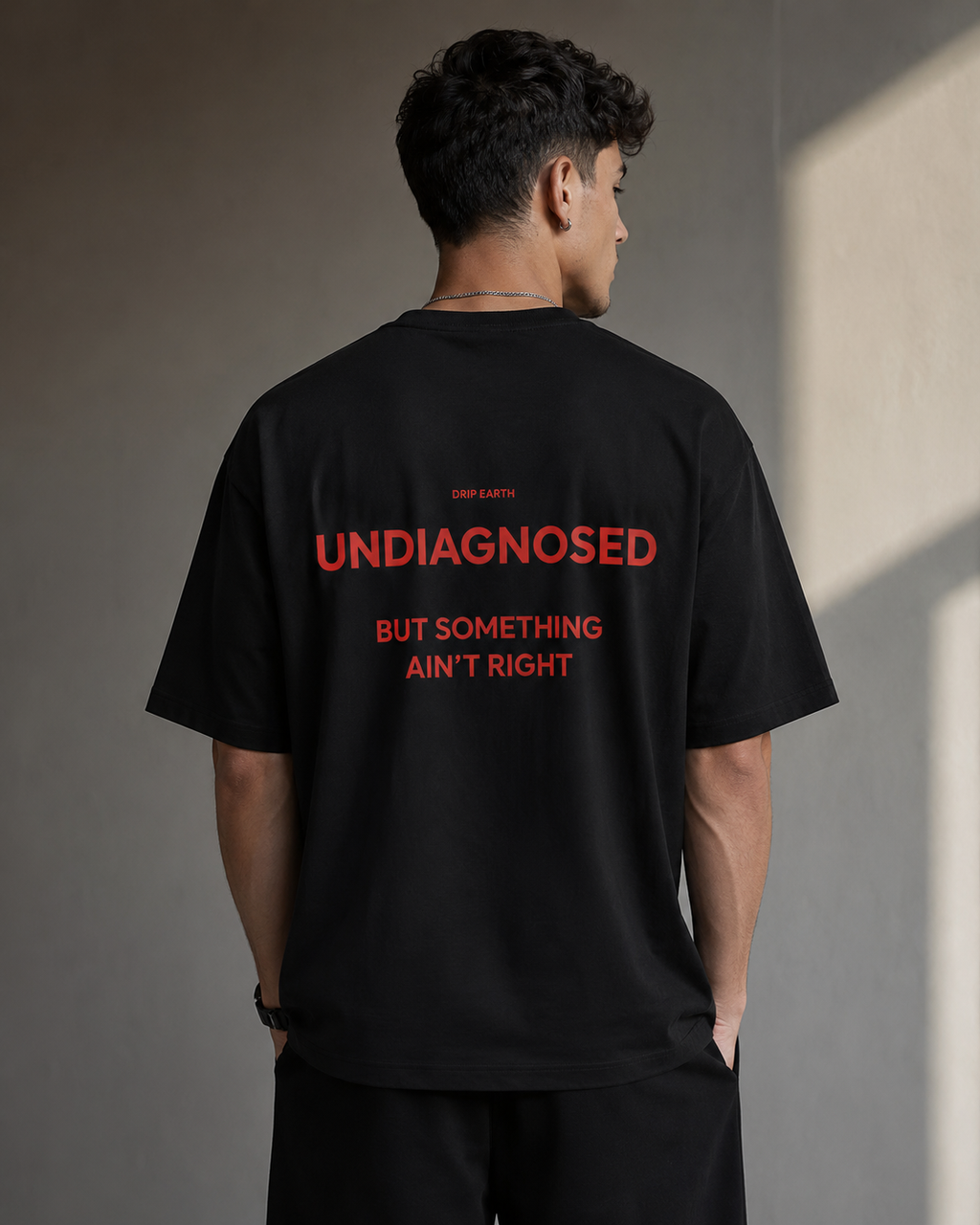 Black Drip Earth premium cotton stretch t-shirt with UNDIAGNOSED back graphic - rear model view