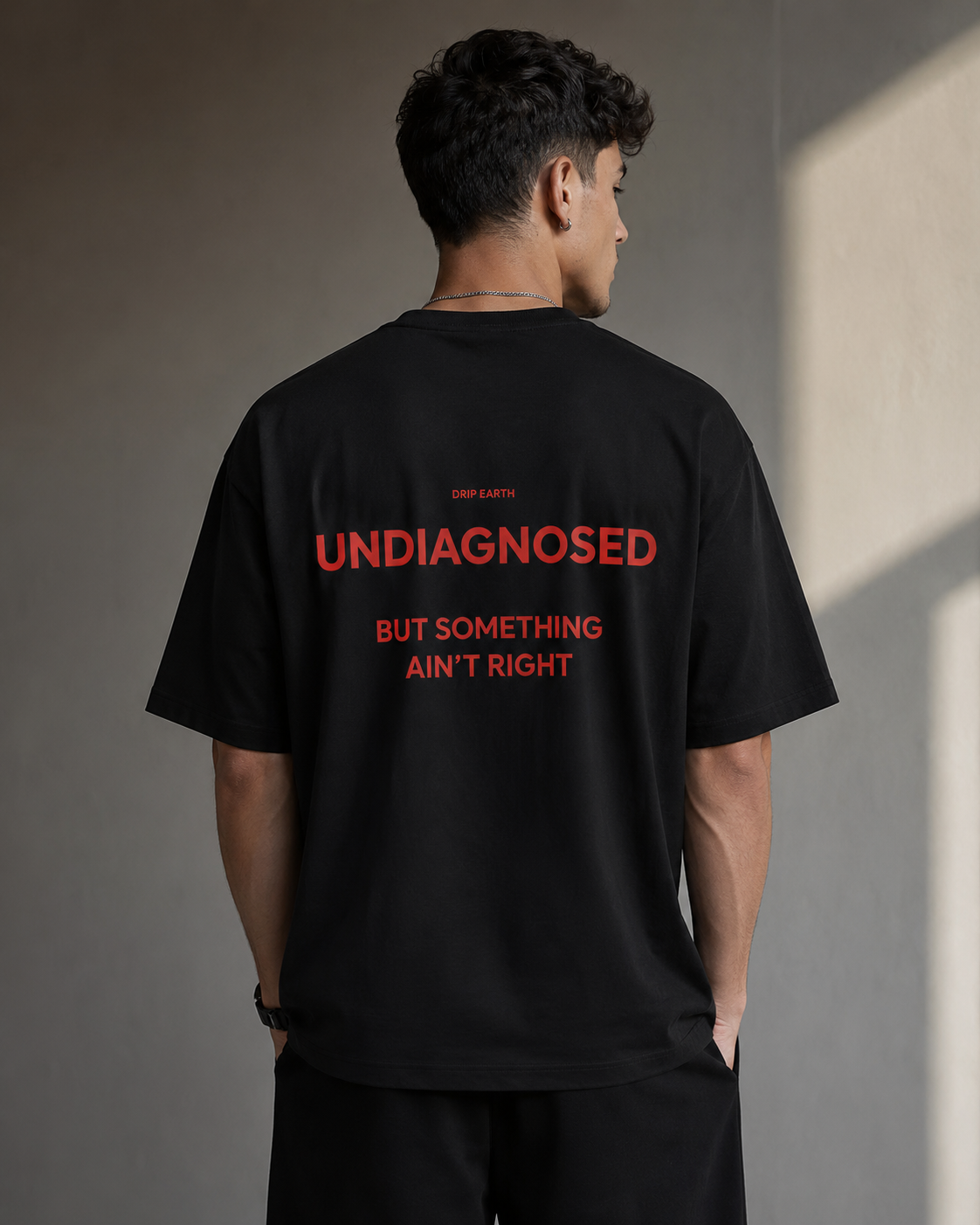 Black Drip Earth premium cotton stretch t-shirt with UNDIAGNOSED back graphic - rear model view