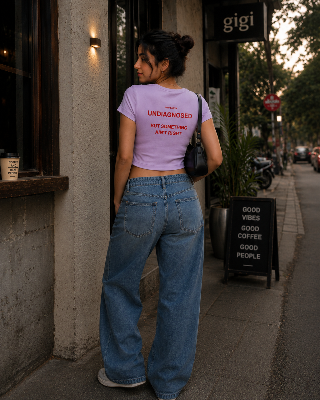 Lavender Drip Earth female baby tee with UNDIAGNOSED graphic - lifestyle streetwear shot