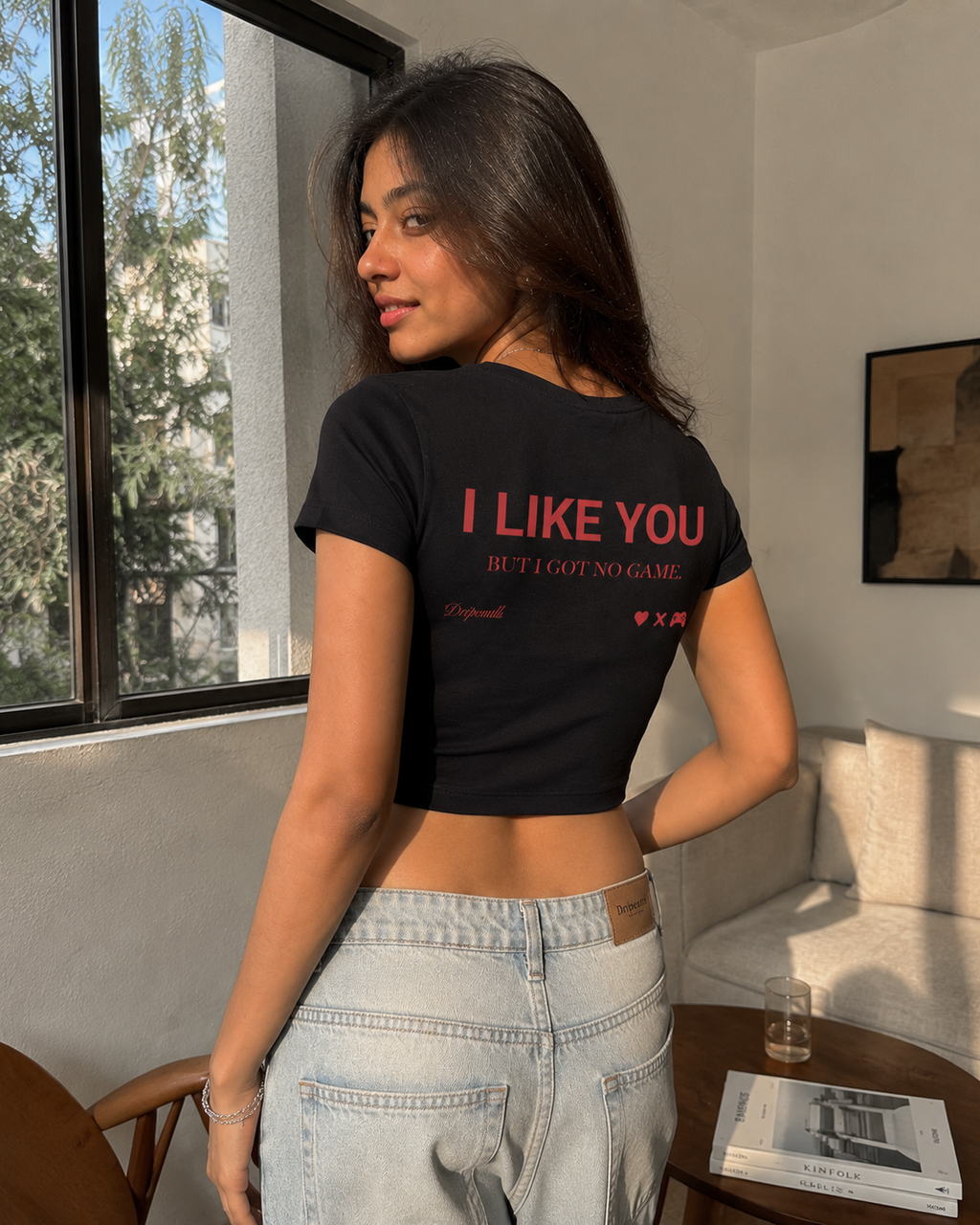 Black Drip Earth female baby tee with UNFILTERED NO GAME graphic - lifestyle streetwear shot
