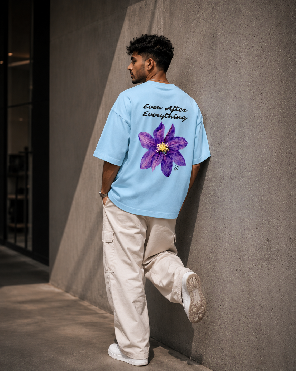 Baby-Blue Still Blooming Premium Oversized T-Shirt in premium urban streetwear lifestyle setting with floral graphic design