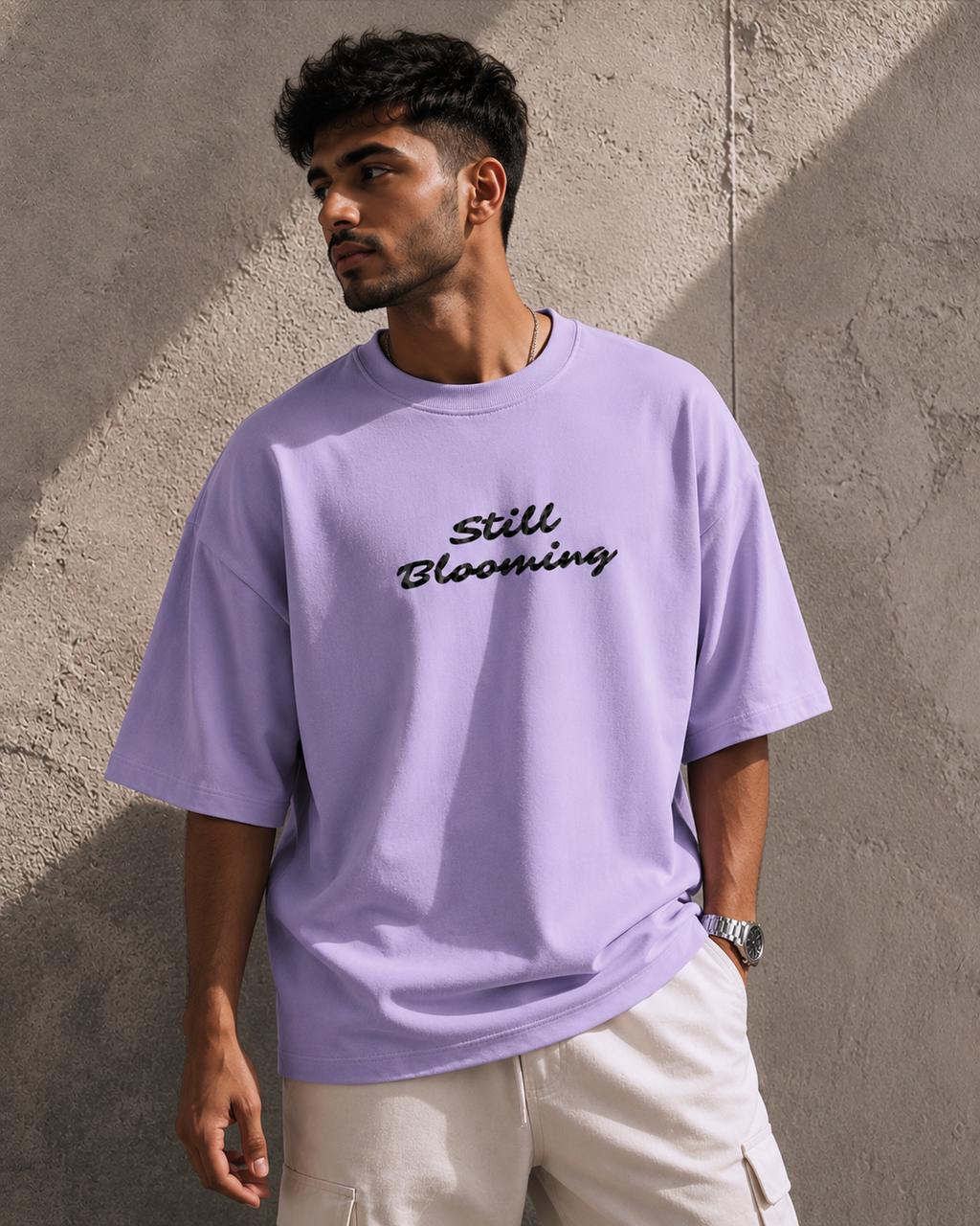 Lavender Still Blooming Premium Oversized T-Shirt front view with Still Blooming typography graphic