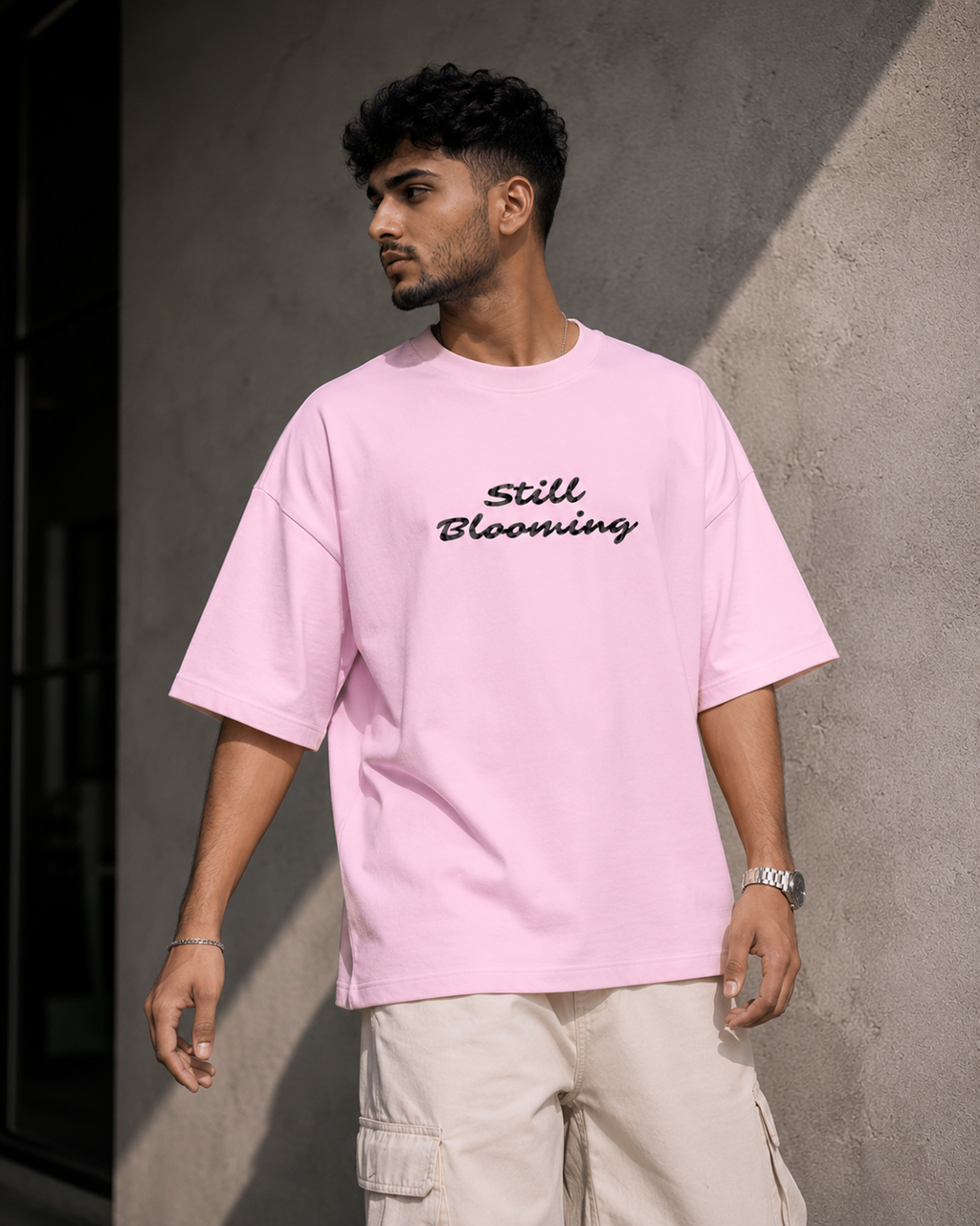 Light-Baby-Pink Still Blooming Premium Oversized T-Shirt front view with Still Blooming typography graphic
