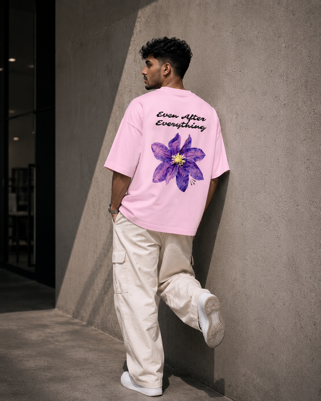 Light-Baby-Pink Still Blooming Premium Oversized T-Shirt in premium urban streetwear lifestyle setting with floral graphic design