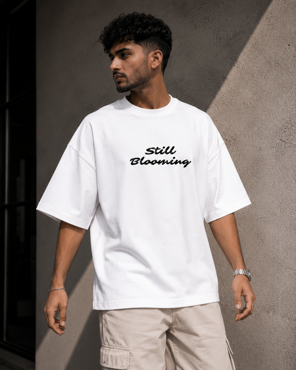 White Still Blooming Premium Oversized T-Shirt front view with Still Blooming typography graphic
