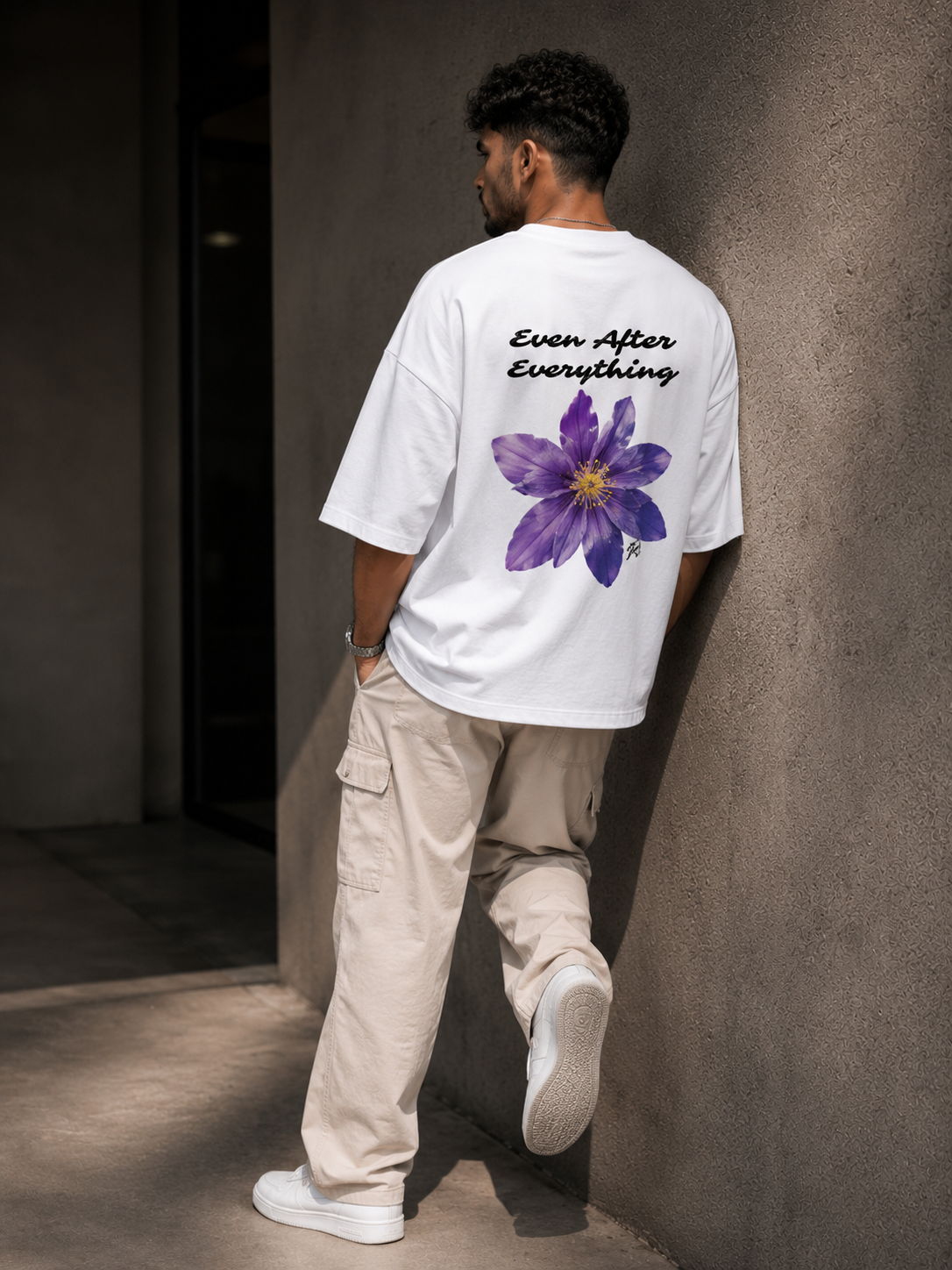 White Still Blooming Premium Oversized T-Shirt in premium urban streetwear lifestyle setting with floral graphic design